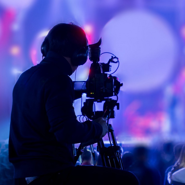 The filmmaker is recording and broadcasting live concerts on cam The filmmaker is recording and broadcasting live concerts on camcorders. Professional Video Recording Business